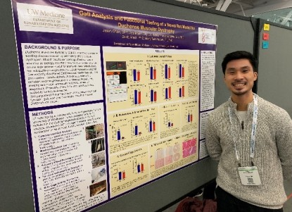 A student next to a conference poster